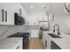 Elegant kitchen featuring marble countertops, modern appliances, and stylish white cabinets at 1625 39Th S St, St Petersburg, FL 33711