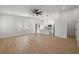 Open-concept living area with hardwood flooring, a ceiling fan, and modern kitchen view at 1625 39Th S St, St Petersburg, FL 33711