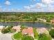 Stunning aerial view of a lakefront property, showcasing manicured lawns and outdoor living spaces at 17923 Arbor Haven Dr, Tampa, FL 33647