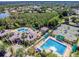 Aerial view showcases a community clubhouse, pools, tennis courts, and beautifully maintained landscaping at 17923 Arbor Haven Dr, Tampa, FL 33647
