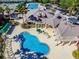 Aerial view features clubhouse amenities like pools and gathering spaces surrounded by palm trees at 17923 Arbor Haven Dr, Tampa, FL 33647