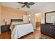 Inviting bedroom with wood floors, ceiling fan, and en-suite bathroom at 17923 Arbor Haven Dr, Tampa, FL 33647