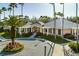 A beautifully landscaped clubhouse entrance framed by mature palm trees creating a welcoming atmosphere at 17923 Arbor Haven Dr, Tampa, FL 33647