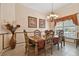 Traditional dining room featuring a decorative chandelier, elegant table set, and abundant natural light from the window at 17923 Arbor Haven Dr, Tampa, FL 33647