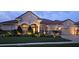 Beautiful home exterior at dusk highlighting lush landscaping and a tile roof at 17923 Arbor Haven Dr, Tampa, FL 33647