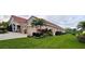 Home exterior showcasing a barrel tile roof, landscaping, and a two-car garage at 17923 Arbor Haven Dr, Tampa, FL 33647