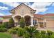 Inviting facade with arched entrance, stone accents, and landscaped garden at 17923 Arbor Haven Dr, Tampa, FL 33647