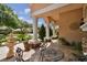 Charming porch featuring elegant columns, wrought iron furniture, and a water feature at 17923 Arbor Haven Dr, Tampa, FL 33647