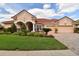 Charming home showcasing a well-manicured lawn, beautiful landscaping, and a welcoming two-car garage at 17923 Arbor Haven Dr, Tampa, FL 33647