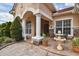 Inviting front entrance with stone pillars, decorative fountain, and seating area at 17923 Arbor Haven Dr, Tampa, FL 33647