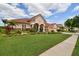 Attractive home with a well-kept lawn, colorful landscaping, and barrel tile roof at 17923 Arbor Haven Dr, Tampa, FL 33647