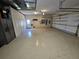 Spacious three-car garage with epoxy floor, storage cabinets, and additional refrigerator offering ample parking at 17923 Arbor Haven Dr, Tampa, FL 33647