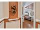 A hallway leads to a bedroom featuring wood floors, ceiling fan, and windows at 17923 Arbor Haven Dr, Tampa, FL 33647