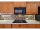 A kitchen with stainless steel appliances and tiled backsplash at 17923 Arbor Haven Dr, Tampa, FL 33647