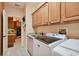 A laundry room featuring built-in cabinets, sink, countertop space and washer/dryer at 17923 Arbor Haven Dr, Tampa, FL 33647