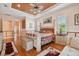 Comfortable main bedroom boasts wood floors, area rugs, and a sitting area at 17923 Arbor Haven Dr, Tampa, FL 33647