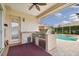 An outdoor kitchen with a sink, grill, stainless steel appliances and view of the pool at 17923 Arbor Haven Dr, Tampa, FL 33647