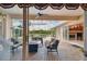 Enclosed patio with a fireplace, outdoor seating, and views of the pool and surrounding greenery at 17923 Arbor Haven Dr, Tampa, FL 33647
