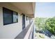 Long community balcony showing several entry doors and dark trim at 1846 Golfview Dr # 1846, Tarpon Springs, FL 34689