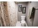 Cozy bathroom featuring a floral shower curtain and neutral wall colors at 1846 Golfview Dr # 1846, Tarpon Springs, FL 34689