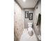 Neutral bathroom with white tile flooring, dark framed mirrors and a plush towel at 1846 Golfview Dr # 1846, Tarpon Springs, FL 34689