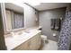 Bathroom featuring a skylight, decorative mirror, and neutral gray wall color at 1846 Golfview Dr # 1846, Tarpon Springs, FL 34689