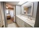 Bathroom with dual vanities, a skylight and an open view into a carpeted bedroom at 1846 Golfview Dr # 1846, Tarpon Springs, FL 34689