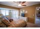 Bedroom with carpet, ceiling fan, bay window, and access to sitting area at 1846 Golfview Dr # 1846, Tarpon Springs, FL 34689