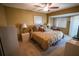 Cozy bedroom featuring a ceiling fan, bay window, and neutral carpet at 1846 Golfview Dr # 1846, Tarpon Springs, FL 34689