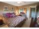 Comfortable bedroom featuring patterned bedspread, mirrored closet doors, and a window at 1846 Golfview Dr # 1846, Tarpon Springs, FL 34689
