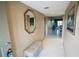 Tiled hallway with mirror, bench, and an open concept living space at 1846 Golfview Dr # 1846, Tarpon Springs, FL 34689