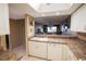 Open concept kitchen with white cabinets and a view to the dining and living area at 1846 Golfview Dr # 1846, Tarpon Springs, FL 34689