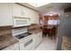 Functional kitchen features white cabinets, modern appliances, and adjacent dining area at 1846 Golfview Dr # 1846, Tarpon Springs, FL 34689
