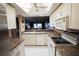Bright kitchen featuring white cabinets, stainless steel refrigerator, and open layout to living area at 1846 Golfview Dr # 1846, Tarpon Springs, FL 34689