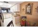 Well-lit kitchen features white cabinets, stainless steel refrigerator, and view to dining area at 1846 Golfview Dr # 1846, Tarpon Springs, FL 34689