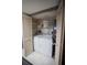 Convenient laundry closet featuring a washer, dryer and shelving at 1846 Golfview Dr # 1846, Tarpon Springs, FL 34689