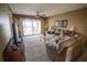 Living room with a ceiling fan and sliding doors to a balcony at 1846 Golfview Dr # 1846, Tarpon Springs, FL 34689