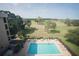 View of the sparkling community pool area and golf course at 1846 Golfview Dr # 1846, Tarpon Springs, FL 34689