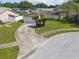 Aerial view of the home showcasing the driveway, manicured lawn, and surrounding neighborhood at 1944 Hastings Ln, Clearwater, FL 33763