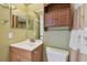 Bathroom features a vanity, mirror, toilet, and tiled shower at 1944 Hastings Ln, Clearwater, FL 33763