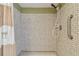 Close up of the tiled shower featuring a shower curtain at 1944 Hastings Ln, Clearwater, FL 33763