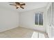This bedroom has a ceiling fan, tiled floors, and closet for storage at 1944 Hastings Ln, Clearwater, FL 33763