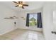 This bedroom has natural light from the window and a ceiling fan at 1944 Hastings Ln, Clearwater, FL 33763