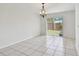Bright dining area with tile flooring, a chandelier, and a sliding glass door leading to the backyard at 1944 Hastings Ln, Clearwater, FL 33763