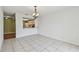 Bright dining area with tile flooring and an ornate chandelier, open to the kitchen at 1944 Hastings Ln, Clearwater, FL 33763