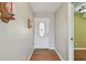 Inviting entryway with a white door, wood-look flooring and neutral walls creating a warm and welcoming ambiance at 1944 Hastings Ln, Clearwater, FL 33763