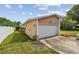 Spacious two-car garage with shingle detailing above and green lawn at 1944 Hastings Ln, Clearwater, FL 33763