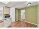 View from kitchen featuring tile floors and stainless steel dishwasher. Green accent paint on the walls at 1944 Hastings Ln, Clearwater, FL 33763