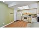 Well-lit kitchen featuring white appliances, ample counter space, and a convenient access door at 1944 Hastings Ln, Clearwater, FL 33763