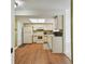 Functional kitchen with white appliances, ample cabinet space, and a skylight providing natural light at 1944 Hastings Ln, Clearwater, FL 33763